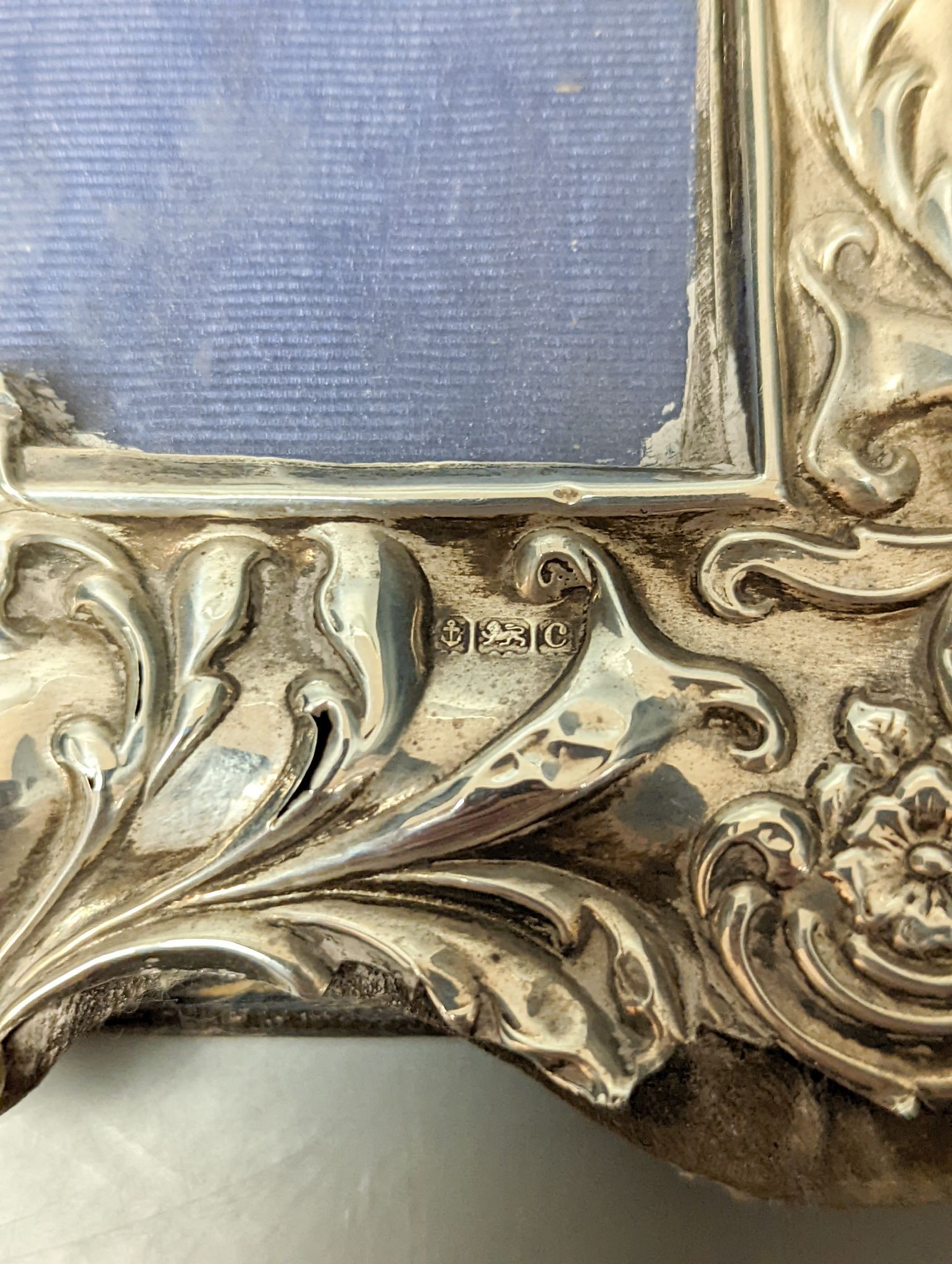 A pair of Edwardian repousse silver mounted photograph frames, Sydney & Co, Birmingham, 1902, 22.5cm (a.f.).